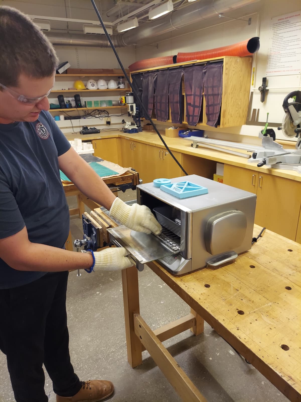 Toaster oven being loaded with tray and tangram mold on top